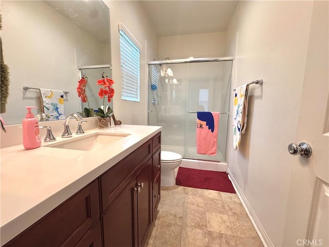 18016 Ribwort Rd, San Bernardino, CA 92407 - full bathroom featuring toilet, vanity, a shower stall, and baseboards