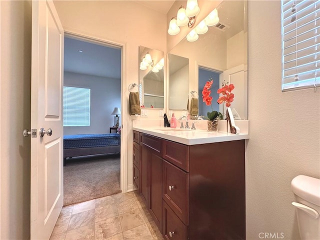 18016 Ribwort Rd, San Bernardino, CA 92407 - bathroom with toilet, vanity, ensuite bath, and a textured wall