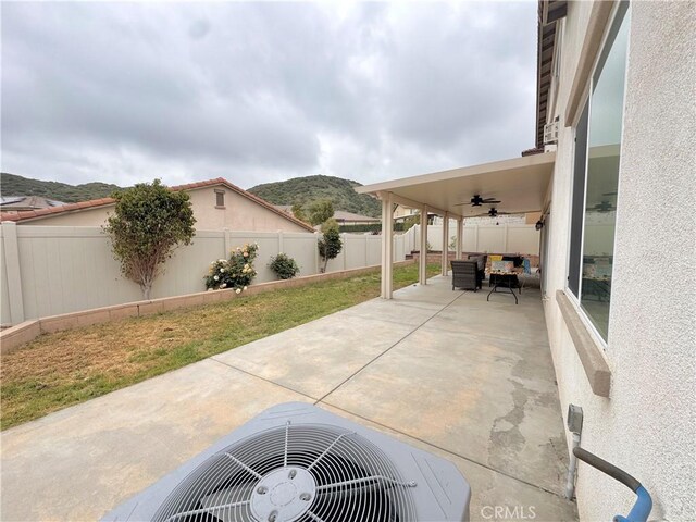 18016 Ribwort Rd, San Bernardino, CA 92407 - view of patio featuring a ceiling fan, a fenced backyard, a mountain view, and central air condition unit