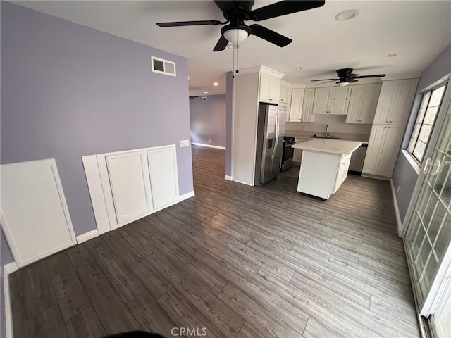 1007 Harrington Way, West Covina, CA 91792 - kitchen with stainless steel fridge, a sink, a ceiling fan, light countertops, and baseboards