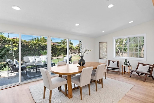 dining room with plenty of natural light, light wood finished floors, vaulted ceiling, and recessed lighting