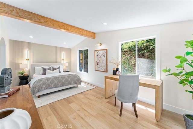 bedroom featuring light wood finished floors, arched walkways, baseboards, and recessed lighting