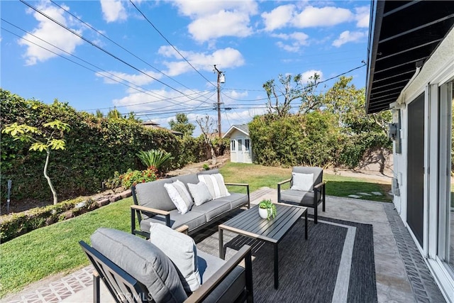view of patio featuring outdoor lounge area and an outbuilding