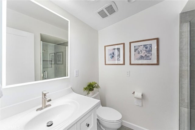 bathroom featuring toilet, a shower stall, vanity, and baseboards