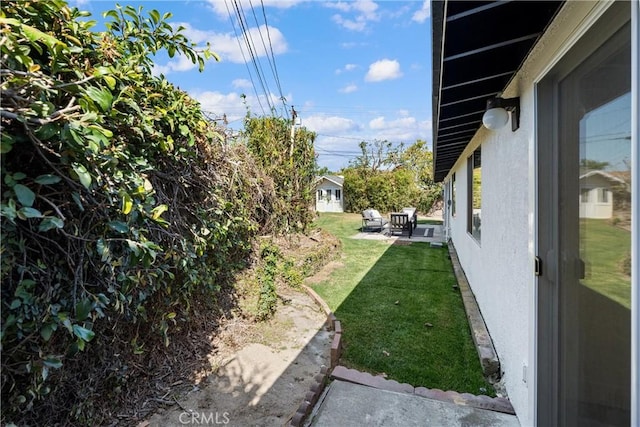 view of grassy yard with a patio