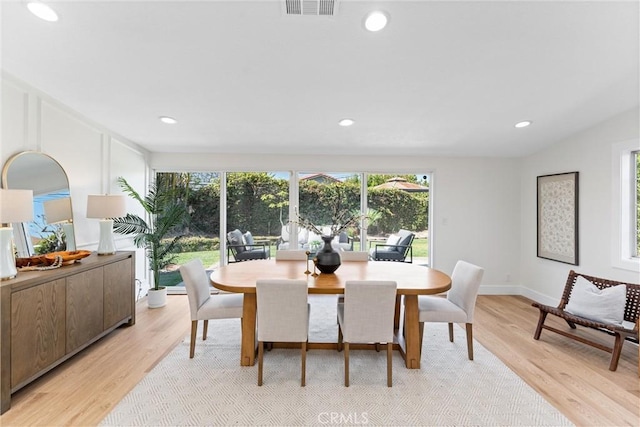 dining room with light wood-style flooring and recessed lighting