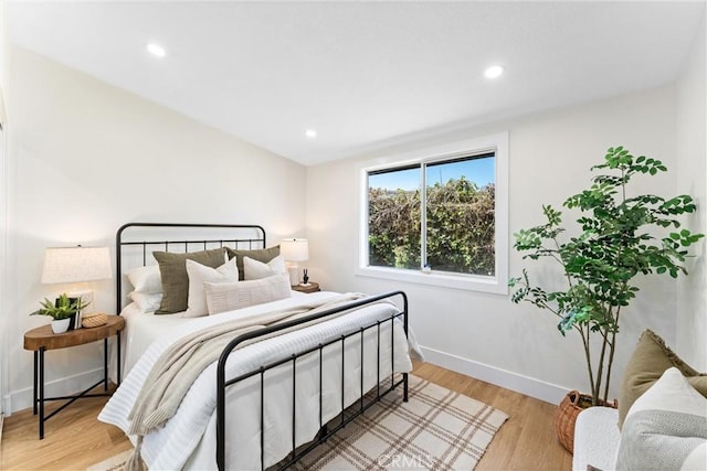 bedroom featuring light wood-type flooring, baseboards, and recessed lighting