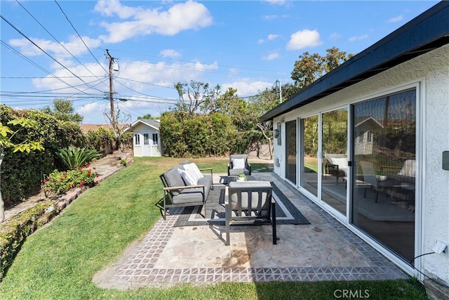 view of patio with an outdoor living space and an outbuilding