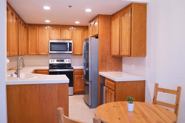 5845 Friars Rd Unit 1316, San Diego, CA 92110 - kitchen featuring stainless steel appliances, a sink, backsplash, light countertops, and recessed lighting