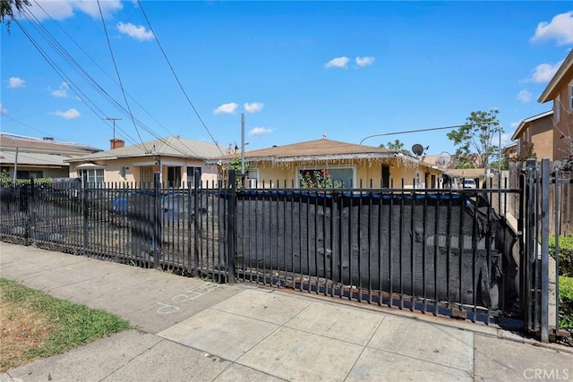 ranch-style home with a fenced front yard