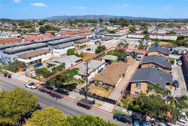 aerial perspective of suburban area with property boundaries highlighted and a mountain backdrop