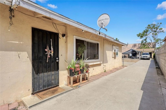 doorway to property featuring stucco siding