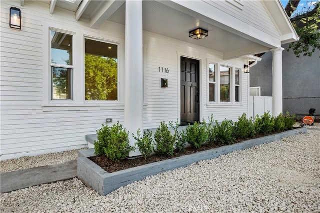 view of exterior entry with a porch