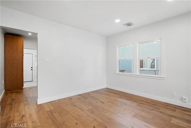 unfurnished room with baseboards, light wood-style floors, and recessed lighting