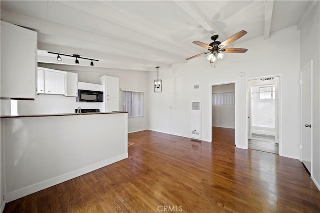 unfurnished living room featuring ceiling fan, wood finished floors, and rail lighting