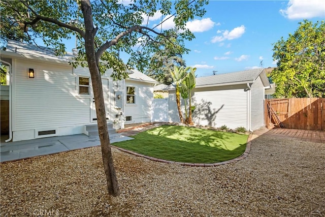 back of house featuring entry steps, a gate, and a patio area