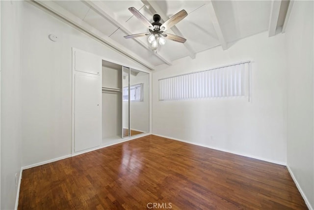 unfurnished bedroom with wood finished floors, a closet, baseboards, and a ceiling fan