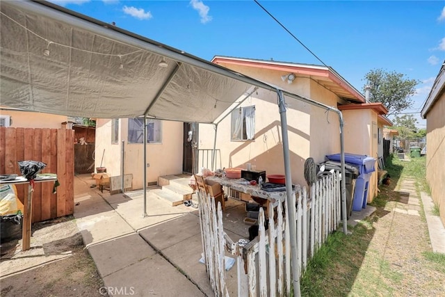 12718 Shreve Rd, Whittier, CA 90602 - rear view of property featuring fence, stucco siding, and a patio