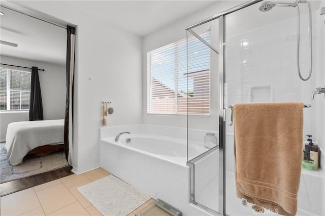 30156 Bristol Gate Ln, Menifee, CA 92584 - bathroom with connected bathroom, a shower stall, a garden tub, and baseboards