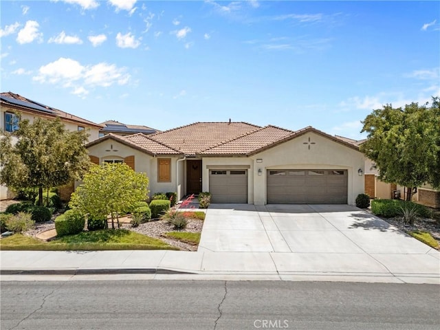 30156 Bristol Gate Ln, Menifee, CA 92584 - mediterranean / spanish-style home with a garage, stucco siding, concrete driveway, and a tiled roof