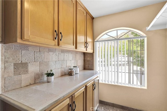 16158 Rimrock Rd, Apple Valley, CA 92307 - kitchen with decorative backsplash, light countertops, and baseboards