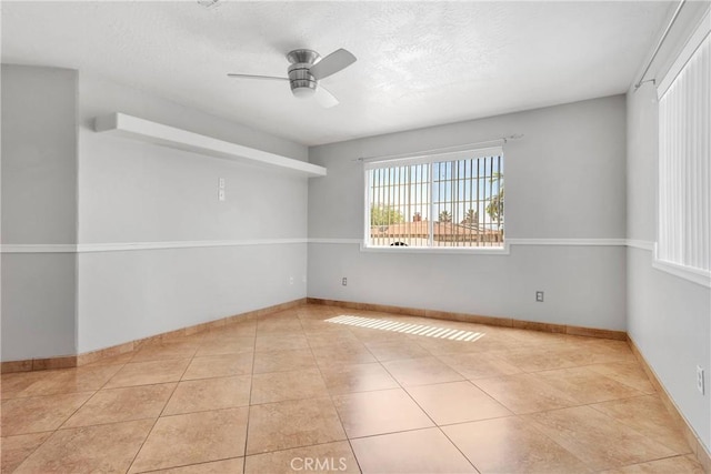 16158 Rimrock Rd, Apple Valley, CA 92307 - tiled empty room with ceiling fan, baseboards, and a textured ceiling