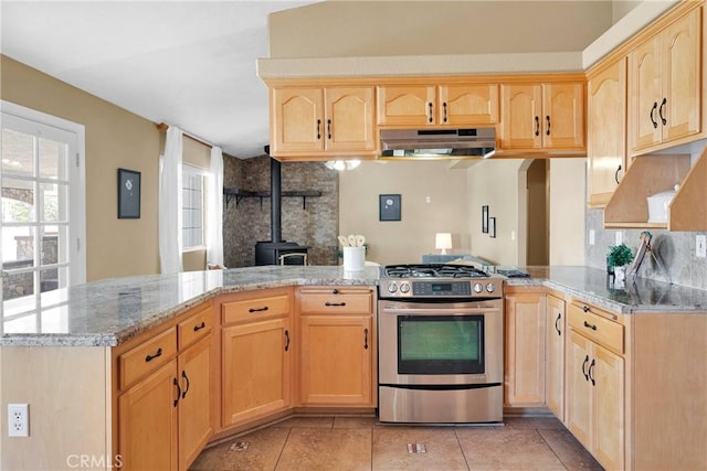16158 Rimrock Rd, Apple Valley, CA 92307 - kitchen with stainless steel range with gas stovetop, under cabinet range hood, light brown cabinetry, and a wood stove