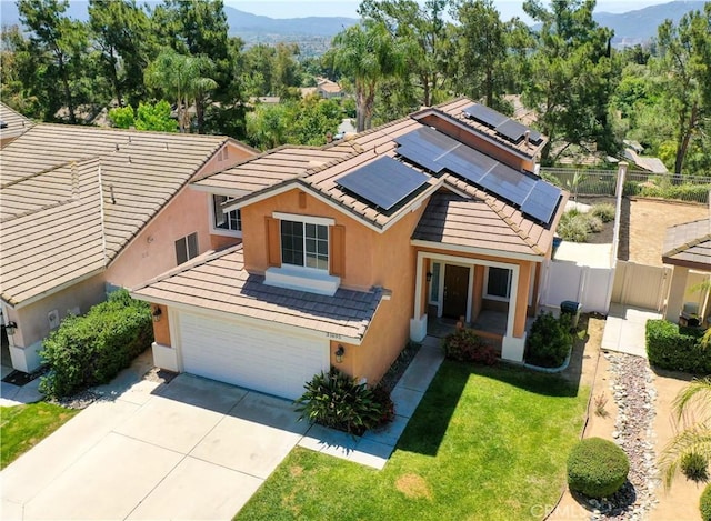 31695 Corte Avalos, Temecula, CA 92592 - view of front facade featuring a mountain view, stucco siding, concrete driveway, solar panels, and a tiled roof
