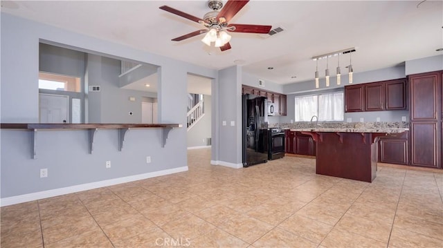 31695 Corte Avalos, Temecula, CA 92592 - kitchen featuring range, a kitchen breakfast bar, black fridge with ice dispenser, a ceiling fan, and decorative light fixtures