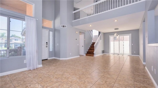31695 Corte Avalos, Temecula, CA 92592 - unfurnished living room featuring stairway, a high ceiling, and a chandelier