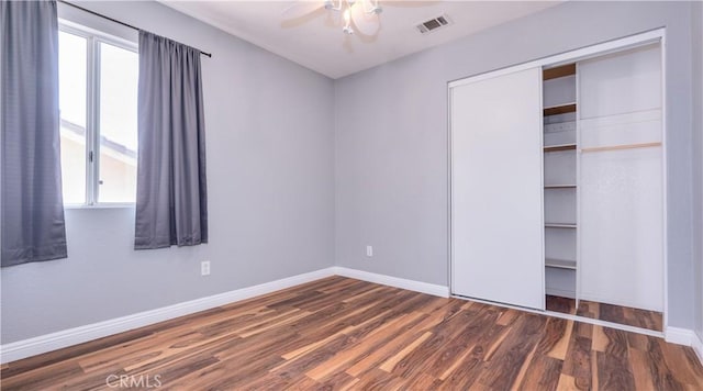 31695 Corte Avalos, Temecula, CA 92592 - unfurnished bedroom featuring multiple windows, wood finished floors, a closet, and a ceiling fan