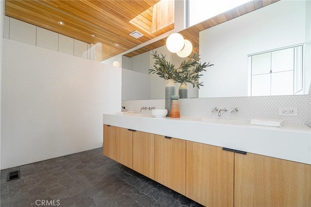 1357 Voorhees Ave, Manhattan Beach, CA 90266 - bathroom featuring wood ceiling, decorative backsplash, and double vanity