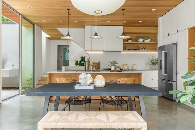 1357 Voorhees Ave, Manhattan Beach, CA 90266 - kitchen featuring high end refrigerator, finished concrete flooring, modern cabinets, backsplash, and wood ceiling
