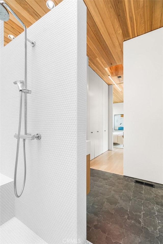1357 Voorhees Ave, Manhattan Beach, CA 90266 - bathroom with wooden ceiling, a tile shower, and stone finish floors