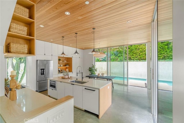 1357 Voorhees Ave, Manhattan Beach, CA 90266 - kitchen with high end fridge, open shelves, a sink, concrete floors, and modern cabinets