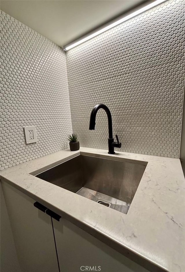 1357 Voorhees Ave, Manhattan Beach, CA 90266 - kitchen view of a sink, decorative backsplash, and light stone counters