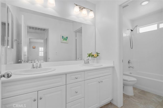 4736 Marrieta St, Jurupa Valley, CA 91752 - bathroom with toilet, double vanity, shower / bath combination, and stone finish floors