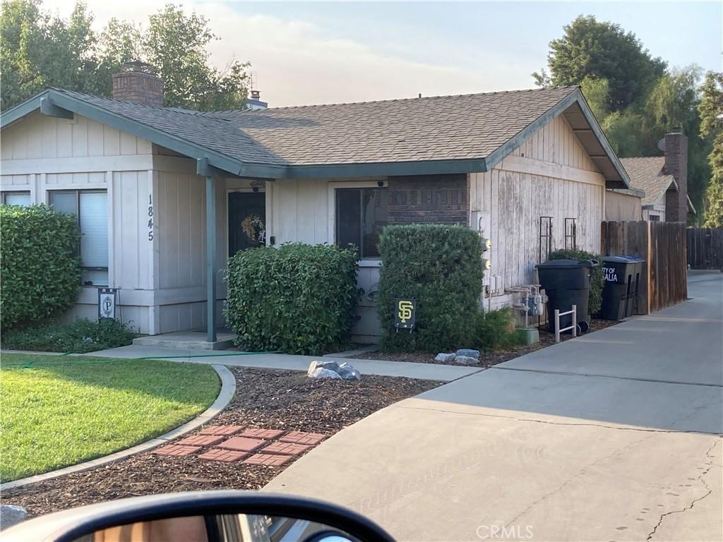 1845 E Laura Ave, Visalia, CA 93292 - view of front of property with roof with shingles and a chimney