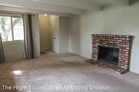 809 Alynn Way, Chico, CA 95973 - unfurnished living room featuring carpet flooring, a fireplace, and beam ceiling