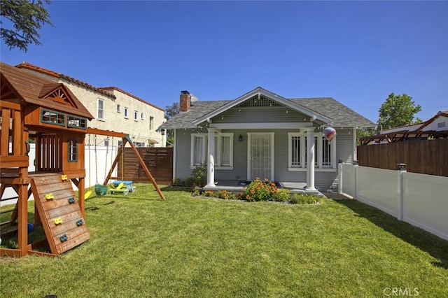 11101 Sarah St, Toluca Lake, CA 91602 - rear view of house with covered porch, a chimney, and a shingled roof