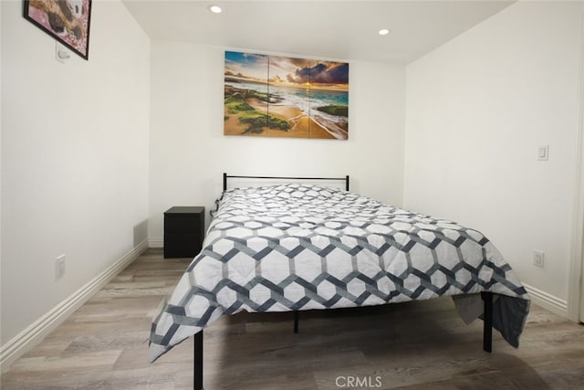 11101 Sarah St, Toluca Lake, CA 91602 - bedroom with wood finished floors, recessed lighting, and baseboards