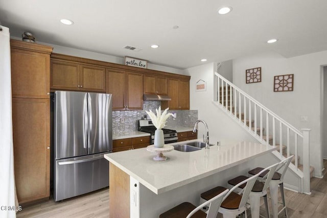 314 Hydrangea St, Fillmore, CA 93015 - kitchen with appliances with stainless steel finishes, brown cabinets, light wood-type flooring, a breakfast bar, and recessed lighting