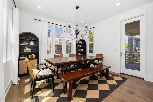 24 Vasto St, Rancho Mission Viejo, CA 92694 - dining room featuring wood finished floors, a chandelier, recessed lighting, baseboards, and built in shelves
