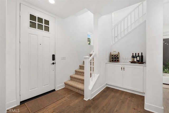 24 Vasto St, Rancho Mission Viejo, CA 92694 - entrance foyer with stairway, dark wood-style flooring, a dry bar, recessed lighting, and baseboards