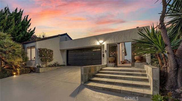 7655 Caminito Avola Ln, Jolla, CA 92037 - view of front of house featuring driveway, stucco siding, and a garage