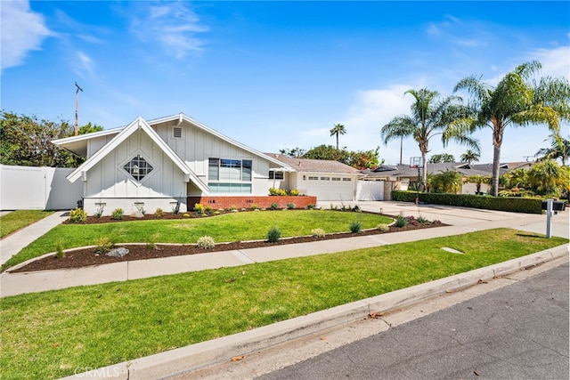 12921 Eveningside Dr, North Tustin, CA 92705 - view of front facade with board and batten siding, an attached garage, and concrete driveway