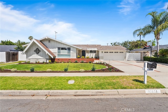 12921 Eveningside Dr, North Tustin, CA 92705 - view of front of property with board and batten siding, an attached garage, and driveway