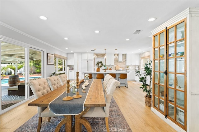 12921 Eveningside Dr, North Tustin, CA 92705 - dining room with recessed lighting, light wood-style floors, ornamental molding, and french doors