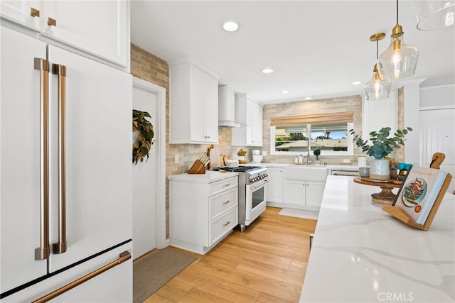12921 Eveningside Dr, North Tustin, CA 92705 - kitchen featuring high quality appliances, wall chimney range hood, white cabinets, backsplash, and recessed lighting