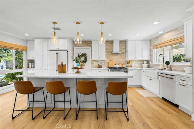 12921 Eveningside Dr, North Tustin, CA 92705 - kitchen featuring a sink, white appliances, wall chimney exhaust hood, a center island, and light countertops